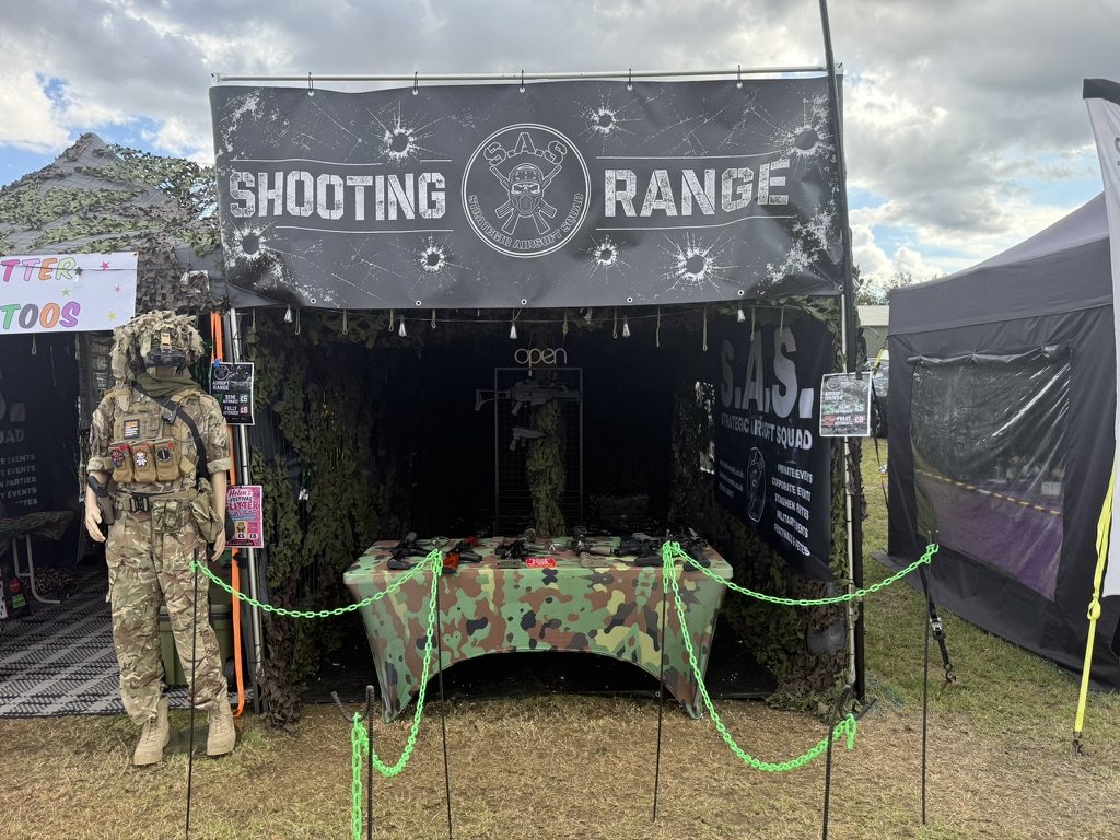 The full range set up at a summer show, banner and camouflage netting overhead